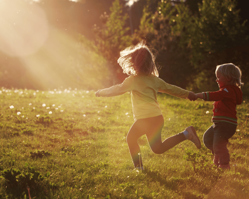Two kids playing outside in the mud